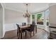 Bright dining room with large bay windows, chandelier, and views of the landscaped front yard at 310 Arbor Creek Trl, Roswell, GA 30076