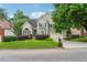 Charming two-story home with manicured lawn, mature trees, and a well-maintained front yard at 310 Arbor Creek Trl, Roswell, GA 30076