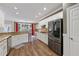 Modern kitchen boasting stainless steel appliances, white cabinetry, granite countertops, and a breakfast area at 310 Arbor Creek Trl, Roswell, GA 30076