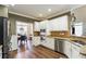 Well-lit kitchen featuring stainless steel appliances, granite countertops, and hardwood floors at 310 Arbor Creek Trl, Roswell, GA 30076