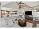 Open concept living room featuring a gray sectional sofa, hardwood floors, staircase, and view into the kitchen at 310 Arbor Creek Trl, Roswell, GA 30076