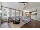 Spacious living room featuring a vaulted ceiling, hardwood floors, and ample natural light from large windows at 310 Arbor Creek Trl, Roswell, GA 30076