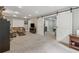 Spacious living room with plush carpeting, large sectional, and sliding barn doors at 310 Arbor Creek Trl, Roswell, GA 30076