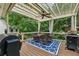 This covered patio has a dining area and built in grill, perfect for outdoor entertaining at 310 Arbor Creek Trl, Roswell, GA 30076