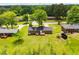 Beautiful aerial view of the brick home surrounded by a lush green lawn and mature trees at 6213 Cherry Ln, Douglasville, GA 30134