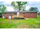 Expansive backyard featuring a brick home, storage shed, and a wooden deck at 6213 Cherry Ln, Douglasville, GA 30134