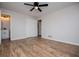 Bedroom with wood flooring, fresh paint, ceiling fan, closet, and an ensuite bathroom at 6213 Cherry Ln, Douglasville, GA 30134