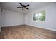 Cozy bedroom featuring hardwood floors, ceiling fan, and ample natural light at 6213 Cherry Ln, Douglasville, GA 30134