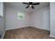 Bedroom featuring hardwood floors, a ceiling fan, neutral paint and a large window at 6213 Cherry Ln, Douglasville, GA 30134