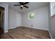 Bright bedroom with hardwood floors, large windows, and a ceiling fan at 6213 Cherry Ln, Douglasville, GA 30134