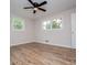 This bedroom features hardwood floors, a ceiling fan, and two windows providing natural light at 6213 Cherry Ln, Douglasville, GA 30134