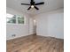 This bedroom features hardwood floors, a ceiling fan, two windows, and a closet at 6213 Cherry Ln, Douglasville, GA 30134