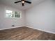 This bedroom features hardwood floors, a ceiling fan, and one window providing natural light at 6213 Cherry Ln, Douglasville, GA 30134