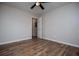 This bedroom features hardwood floors, a ceiling fan, and a door to another room at 6213 Cherry Ln, Douglasville, GA 30134