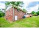 Brick home exterior with white trim, side door, and a green lawn at 6213 Cherry Ln, Douglasville, GA 30134