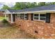 Side view of the beautiful brick house showing window shutters and green landscaping at 6213 Cherry Ln, Douglasville, GA 30134