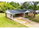 A charming brick home featuring a carport and well-maintained yard at 6213 Cherry Ln, Douglasville, GA 30134