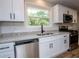 Kitchen featuring white cabinets, stainless appliances, and granite countertops at 6213 Cherry Ln, Douglasville, GA 30134