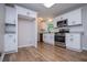 Modern kitchen featuring white cabinets, stainless appliances, and wood flooring at 6213 Cherry Ln, Douglasville, GA 30134