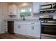 Kitchen with white cabinetry, granite counters, and stainless steel appliances at 6213 Cherry Ln, Douglasville, GA 30134