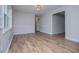 Open living room featuring wood flooring, neutral paint, and trim details at 6213 Cherry Ln, Douglasville, GA 30134