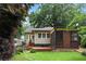 Beautiful backyard featuring a screened porch, deck, and well-maintained landscaping at 628 Home Se Ave, Atlanta, GA 30312