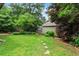 Lush backyard with green lawn, mature trees, foliage, and garden area, perfect for outdoor enjoyment at 628 Home Se Ave, Atlanta, GA 30312