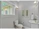 Small bathroom with decorative artwork, a modern sink, and natural light from the window at 628 Home Se Ave, Atlanta, GA 30312