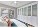 Bright bedroom boasts floor-to-ceiling closet storage, a ceiling fan, and natural light at 628 Home Se Ave, Atlanta, GA 30312
