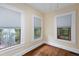 Well lit bedroom featuring beautiful hardwood floors and three large windows at 628 Home Se Ave, Atlanta, GA 30312