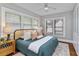 Cozy bedroom featuring a queen bed, ceiling fan, and three windows allowing natural light at 628 Home Se Ave, Atlanta, GA 30312