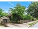 Charming home exterior with a fenced yard, detached garage, and mature trees at 628 Home Se Ave, Atlanta, GA 30312
