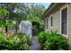 Landscaped side yard with flowering bushes, a stone pathway, and fenced garden, adding charm and privacy at 628 Home Se Ave, Atlanta, GA 30312
