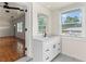 Bright bathroom featuring a white vanity with marble countertop and a window with natural light at 821 Springvalley Dr, Forest Park, GA 30297