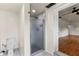 Modern bathroom with a glass-enclosed shower and toilet, leading to another room at 821 Springvalley Dr, Forest Park, GA 30297