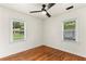 Sunlit bedroom with hardwood floors, ceiling fan, and large windows, offering a relaxing retreat at 821 Springvalley Dr, Forest Park, GA 30297