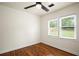 Bright bedroom with hardwood floors, ceiling fan, and sun-filled windows at 821 Springvalley Dr, Forest Park, GA 30297
