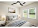 Bedroom features a queen bed, nightstands and plenty of natural light at 821 Springvalley Dr, Forest Park, GA 30297