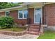 Inviting front entrance features decorative ironwork and charming brick stairs at 821 Springvalley Dr, Forest Park, GA 30297
