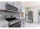 Renovated kitchen featuring stainless steel appliances and contemporary backsplash at 821 Springvalley Dr, Forest Park, GA 30297