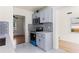 Bright kitchen with stainless steel appliances and gray cabinets, with an adjacent dining area at 821 Springvalley Dr, Forest Park, GA 30297