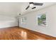 Bright living room with gleaming hardwood floors and natural light from large windows at 821 Springvalley Dr, Forest Park, GA 30297