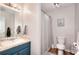 This bathroom features a sink with a tiled countertop and a shower with a white shower curtain at 1809 Brandi Ln, Loganville, GA 30052