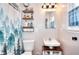 Charming bathroom featuring forest-themed shower curtain, open shelves, and a classic sink at 1809 Brandi Ln, Loganville, GA 30052