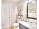 Bathroom featuring a marble-top vanity, toilet, mirror and decorative artwork at 1809 Brandi Ln, Loganville, GA 30052