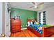 Bedroom features a solid wood frame bed, hardwood floors, and large window at 1809 Brandi Ln, Loganville, GA 30052