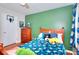 Bedroom features a solid wood frame bed, hardwood floors, and a green accent wall at 1809 Brandi Ln, Loganville, GA 30052