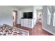 Bedroom with hardwood floors, dresser, TV, and access to the bathroom and other rooms at 1809 Brandi Ln, Loganville, GA 30052