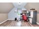 Attic-style office space with hardwood floors, multiple computer setup, and sloped ceilings at 1809 Brandi Ln, Loganville, GA 30052
