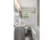 Well-lit bathroom with a white vanity, tub, and natural light at 2288 Scotty Cir, Decatur, GA 30032
